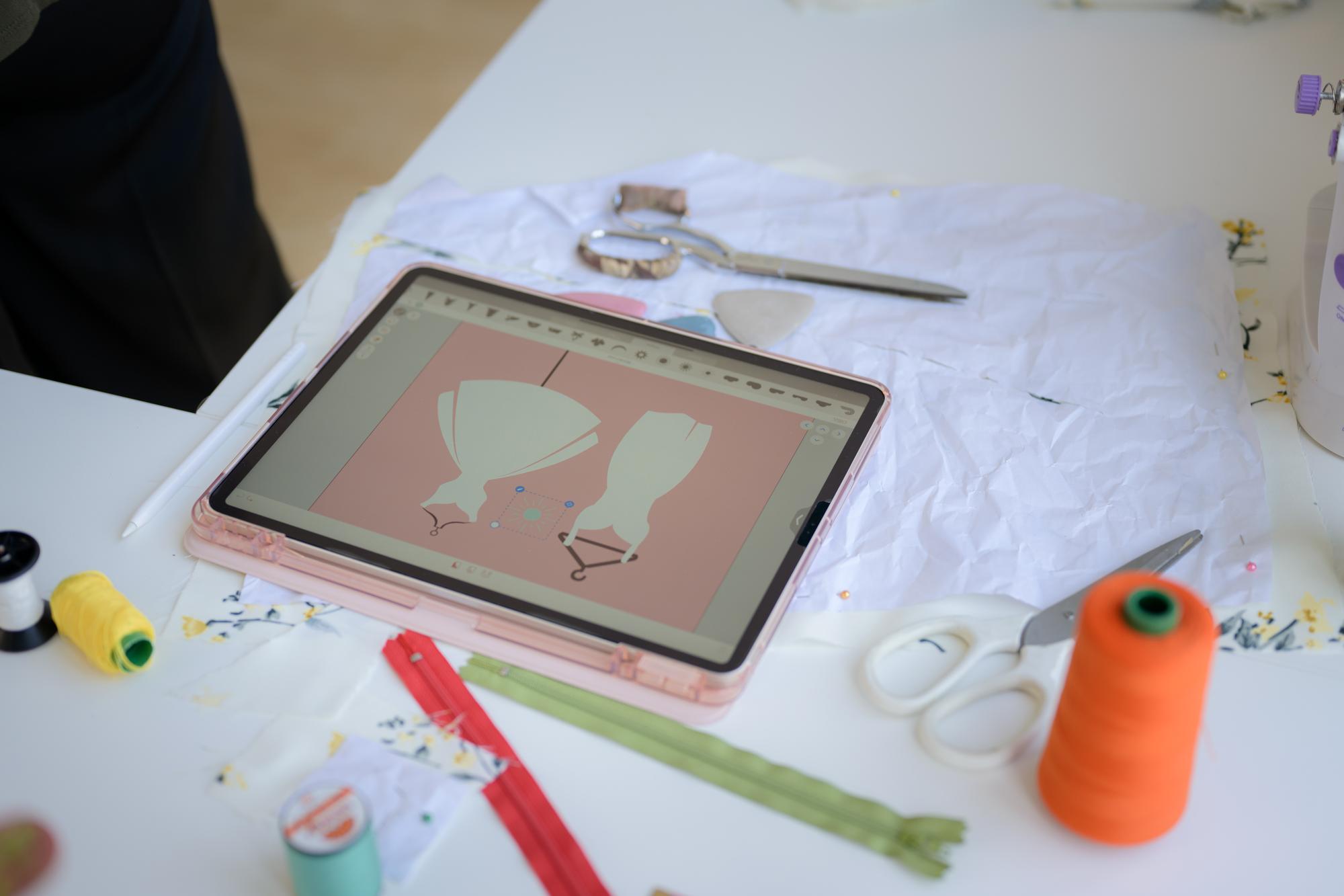 atelier workstation with hoop, threads and tablet showing pattern