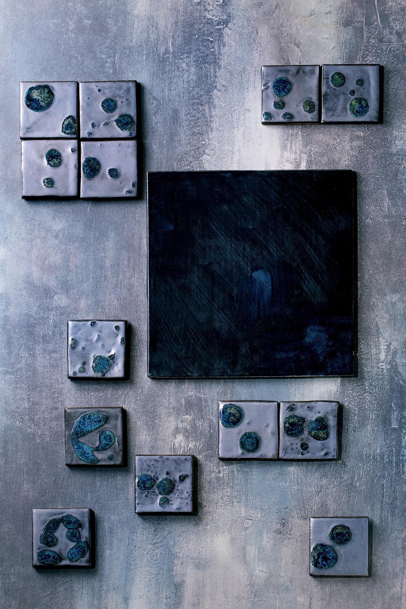 studio wall with framed embroidered panels